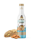 Sugar-free syrup bottle with almond biscotti and almonds on a white background