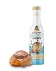 Bottle of sugar-free Sinless Syrup Cinnamon Dolce and cinnamon bun on white background