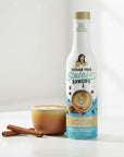 sugarfree Cinnamon Dolce Sinless Syrup bottle with cinnamon coffee on white background