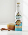 sugarfree Cinnamon Dolce Sinless Syrup bottle with cinnamon coffee on white background