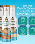 Fireside Collection of sugar free Sinless Syrups with graphics showing uses like coffee, yogurt, cocoa on blue background.