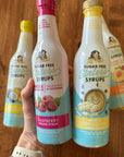 Bottles of sugar-free syrups on a wooden surface