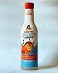Miss Mary's Pumpkin Spice Sugar Free Sinless Syrup bottle on blue background