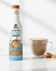 sugar free Salted Caramel Sinless Syrup bottle and coffee on white background