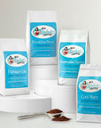 four bags of Sinless Coffee varieties on white background