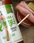 Miss Mary's Thick & Savory Bloody Mary Mix with meat garnish on brown background