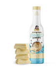 Sugar Free Sinless Syrups bottle with white chocolate blocks on a white background