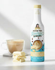 White Chocolate sugarfree Sinless Syrup Bottle with white chocolate pieces on white background