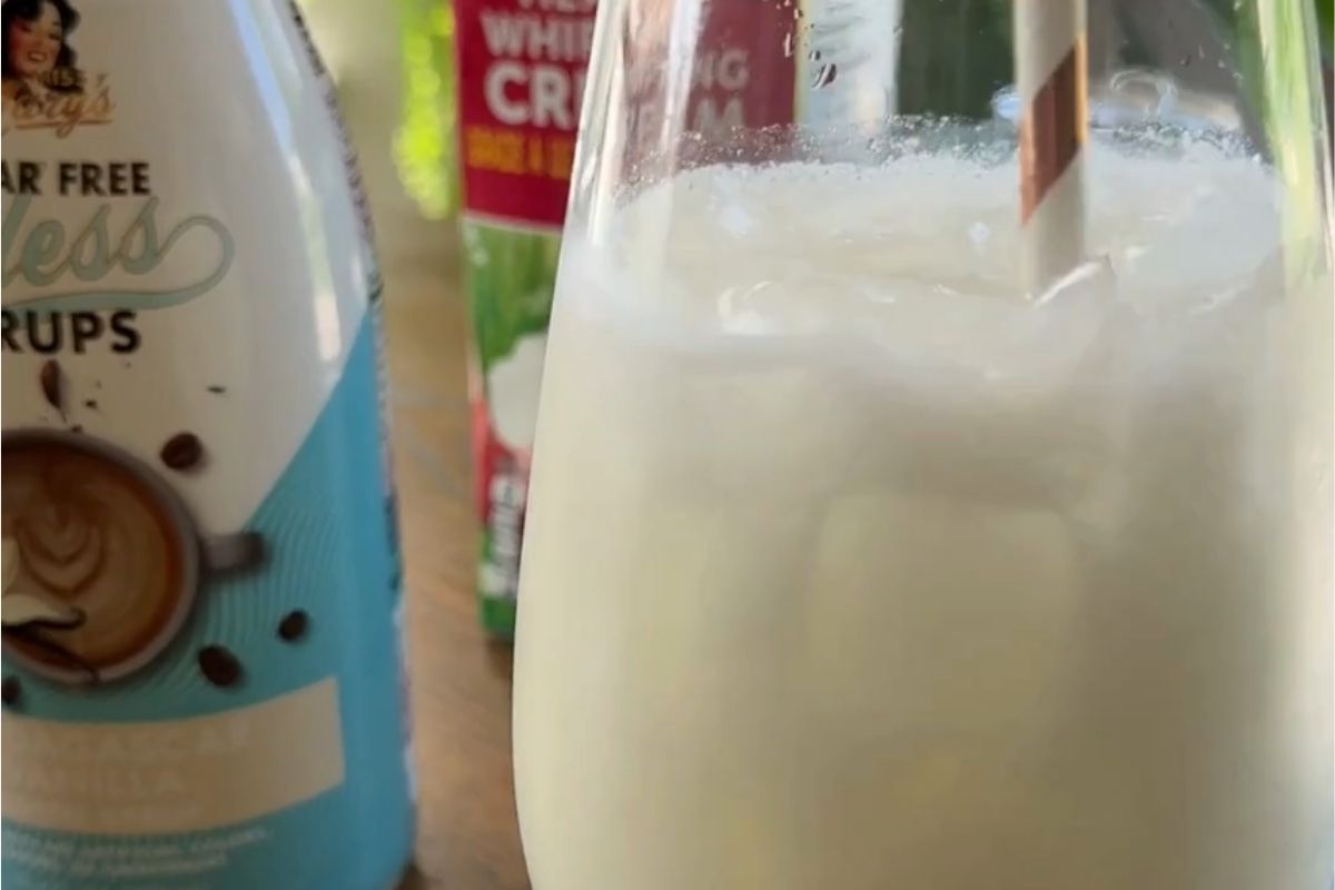 Dirty soda closeup with sinless madagascar vanilla syrup bottle