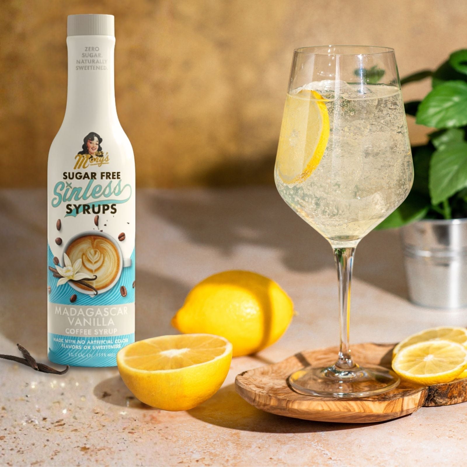 Lemon Vanilla Spritz cocktail with Madagascar Vanilla syrup bottle on beige background