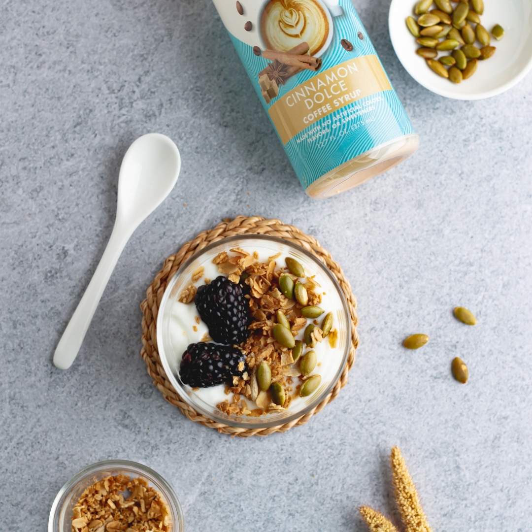 Bottle of sugar-free Cinnamon Dolce syrup with yogurt on grey counter