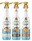 Three bottles of classic, sugar-free coffee syrups and bottle pumps on a white background