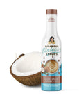Bottle of sugar-free syrup with a coconut on a white background