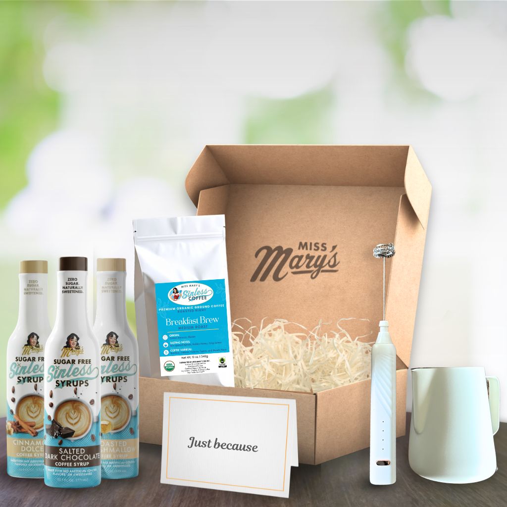 Gift box with Miss Mary's branding, including coffee products and a toothbrush, on a wooden surface.