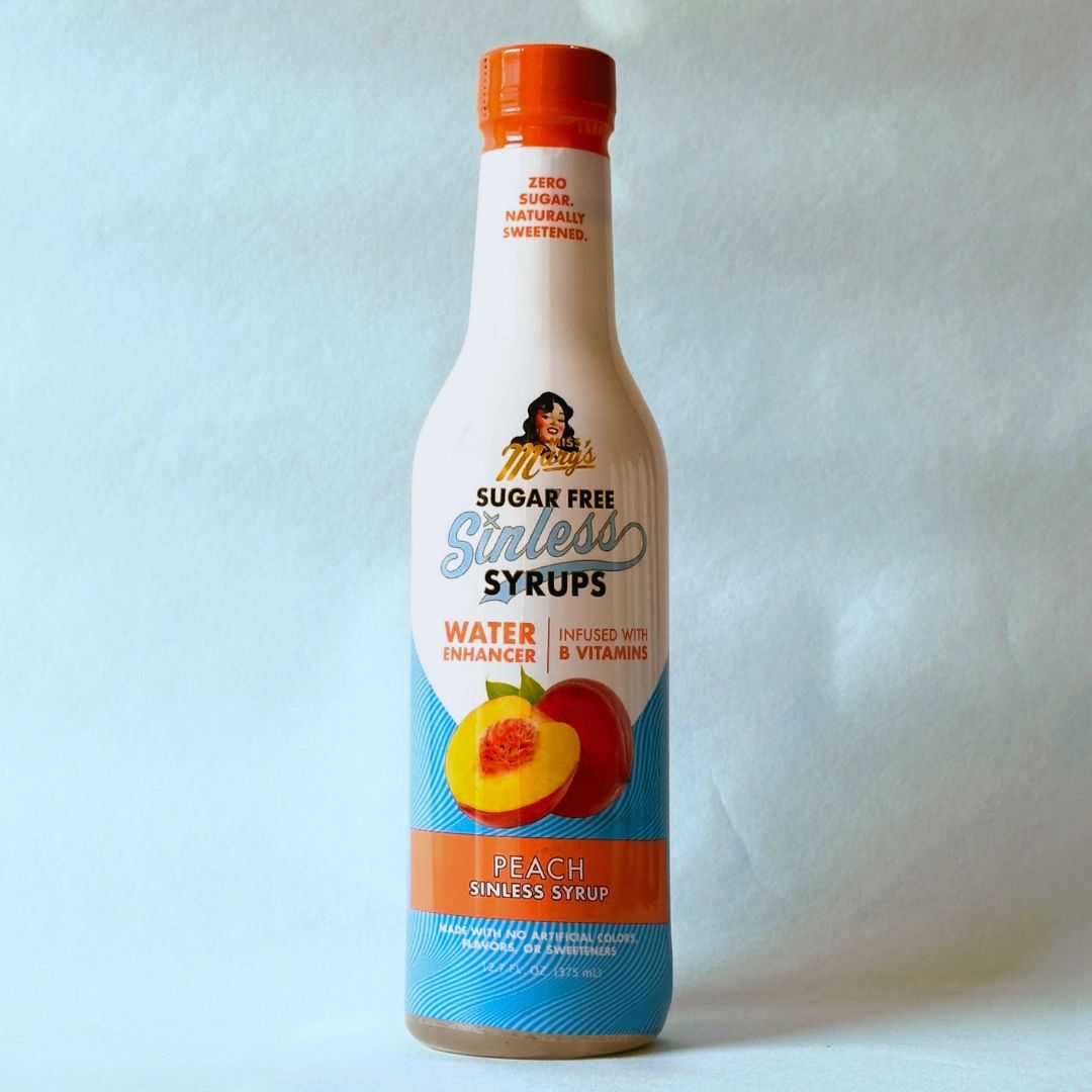 Miss Mary's Peach Sugar Free Sinless Syrup bottle on blue background