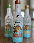 Coconut Sugar Free Sinless Syrup and other bottles on a wooden surface.