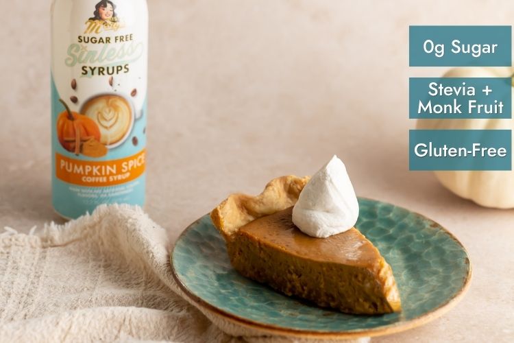 A bottle of pumpkin spice coffee syrup stands next to a slice of pumpkin pie on a teal plate with a whipped cream topping. Three teal text boxes on the right read 'Og Sugar', 'Stevia + Monk Fruit', and 'Gluten-Free'.