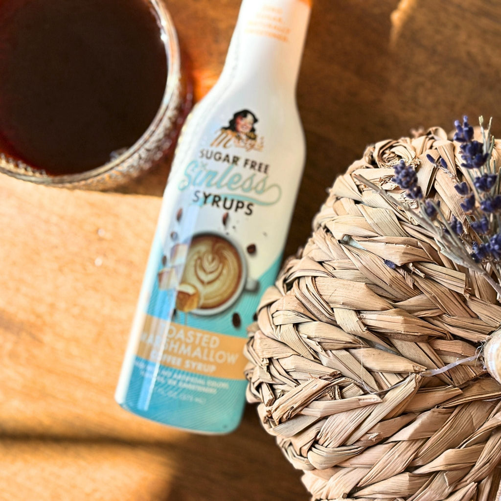 Bottle of toasted marshmallow coffee syrup from Miss Mary's Mix next to wicker pumpkin and glass coffee cup