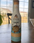 Bottle of Sugar Free Syrups Toasted Marshmallow Coffee Syrup on a table with a blurred outdoor background